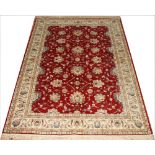 A Kashmir Ziegler carpet, worked with an all over foliate design against a red ground,