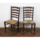 A set of four late 19th Century beech and ash ladder back dining chairs, with rush seats,