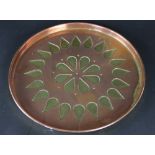 A copper and brass circular serving tray,