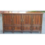 A late Victorian walnut dresser, with four panelled doors, on tapered square legs,