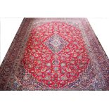 A large Persian Mashad hand woven wool carpet,