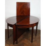 A George III mahogany D end dining table, one end with attached flap, with one loose leaf,