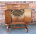 A Sylvaphone oak cabinet gramophone, with two doors enclosing an oval jet speaker,