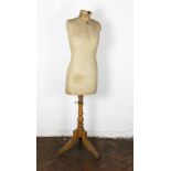 A vintage beech mannequin with brass nut , on tripod base,