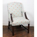 A George III mahogany Gainsborough style arm chair, with floral blue upholstery,
