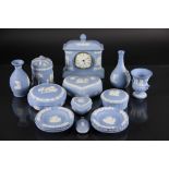 A collection of Wedgewood blue Jasper ware, to include, a matel time piece, a jar and cover,