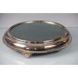 A silver plated mirror top cake stand/centrepiece with bracket feet, 38cm diameter,