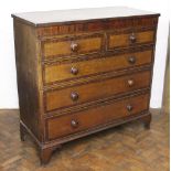 An early 19th century oak and mahogany cross banded chest,