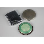 A silver and green enamel circular compact, Birmingham 1941, an Art Deco circular silver compact,