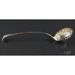 A George III silver ladle, with scroll terminal and shell shaped bowl, London c1770,