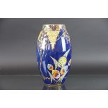 A Carlton Ware Art Deco oval vase, decorated with two sprays and a tree with stylised flowers,
