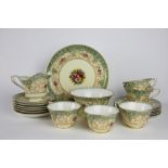 A Royal Worcester twenty one piece bone china tea service, painted with floral sprays by J Goodwin,