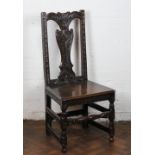 An 18th century oak side chair with later carved foliate detailing,