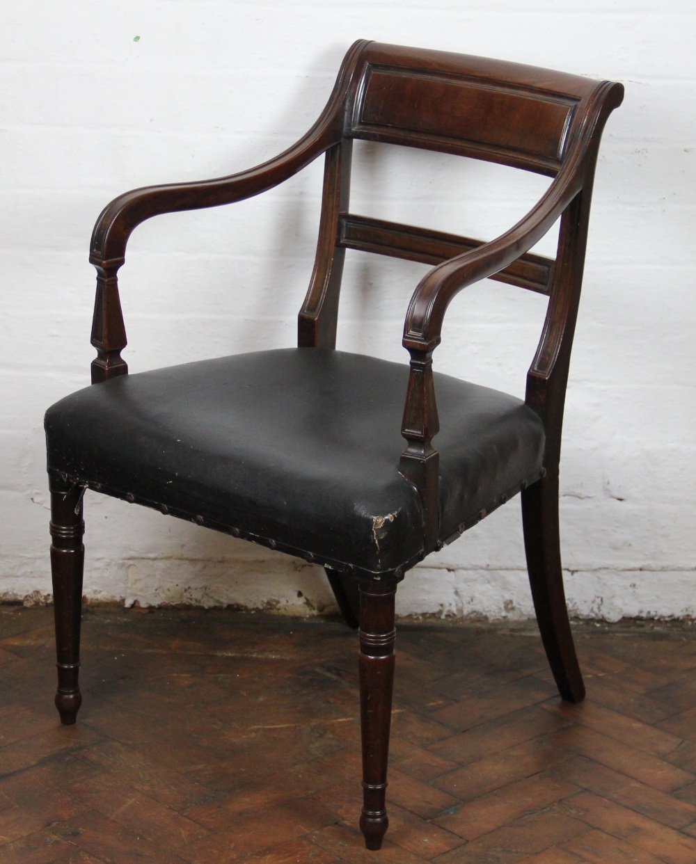 A Regency mahogany carver dining chair, with panelled back and upholstered seat,