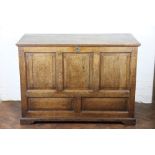 A large George III oak coffer, with hinged top above a panelled front, on bracket feet, 88.