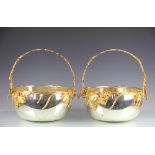 A pair of silver and gold plated wine coolers,