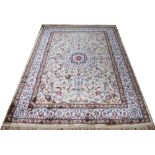 A Kashmir carpet worked with an all over foliate design against a gold ground,