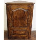 A modern pine hanging corner cabinet, with panelled door,