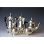 A silver five piece tea and coffee service, comprising tea pot, hot water pot, coffee pot,