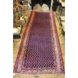 A Caucasian wool ground runner worked with a simple geometric design against a blue ground,