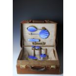 A George V pig skin dressing case with silver and blue enamel fittings,