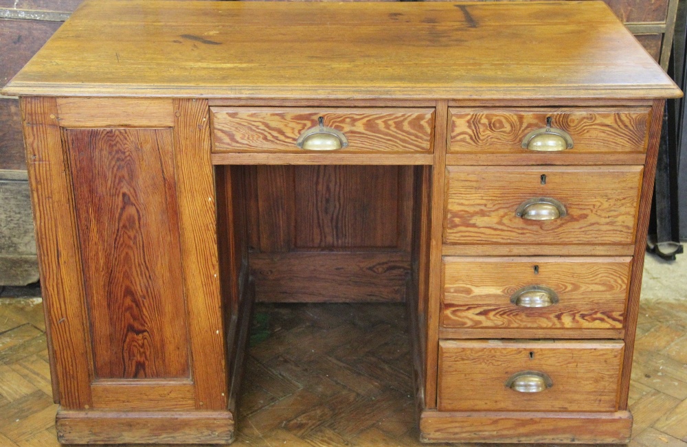 An Edwardian pitch pine pedestal desk,