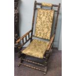 An American style walnut rocking chair, with upholstered back, seat and arms,