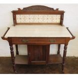 A late Victorian walnut marble top wash stand, with tile back above a drawer and cupboard door,
