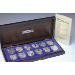 A set of ten silver 'The Royal Arms' medallions, by The Danbury Mint, each approx 48g,