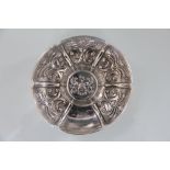 An Edwardian silver dish, of circular form and with repousse segmented panels,