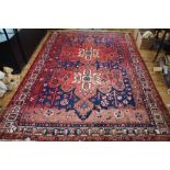 A Persian Bakhtiari wool carpet worked with two large geometric gulls against a blue ground,