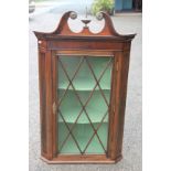 An Edwardian mahogany corner cabinet,