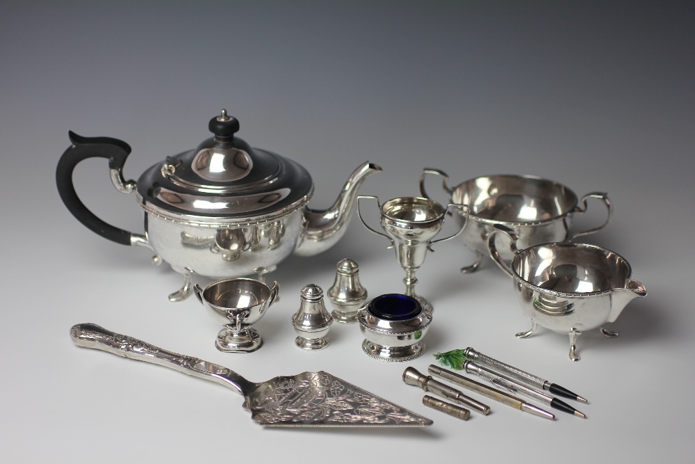 A pair of silver condiments, two small silver trophies,