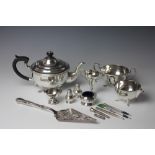 A pair of silver condiments, two small silver trophies,