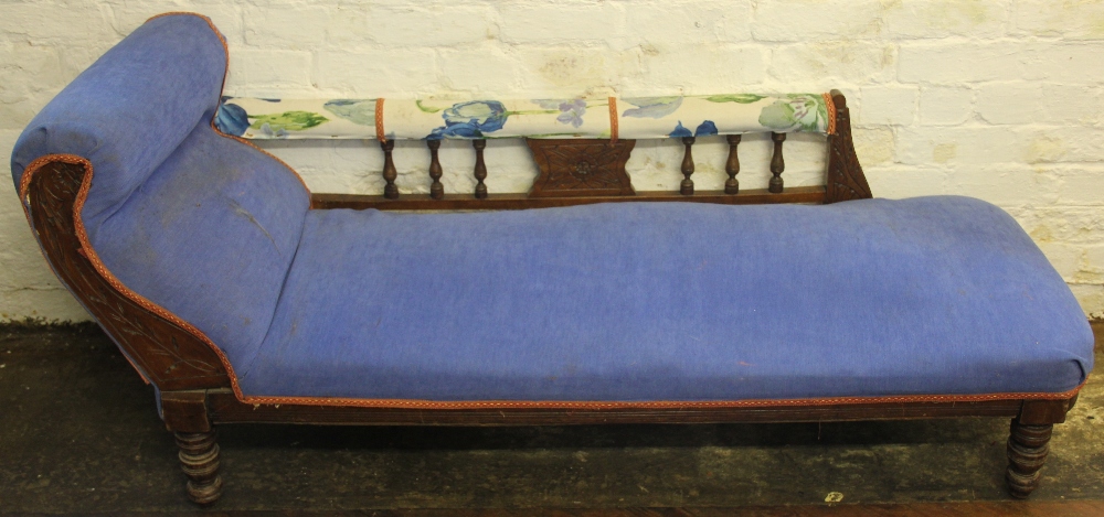 A Victorian carved walnut Chaise long, on turned legs,