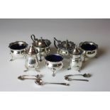 A silver condiment set, each piece of cauldron form with blue glass liner, to include,