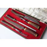 A five piece carving set, with horn handles and sterling silver collars,