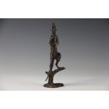 A bronze effect statue of a Meerkat, modelled standing upon a branch, 'S.