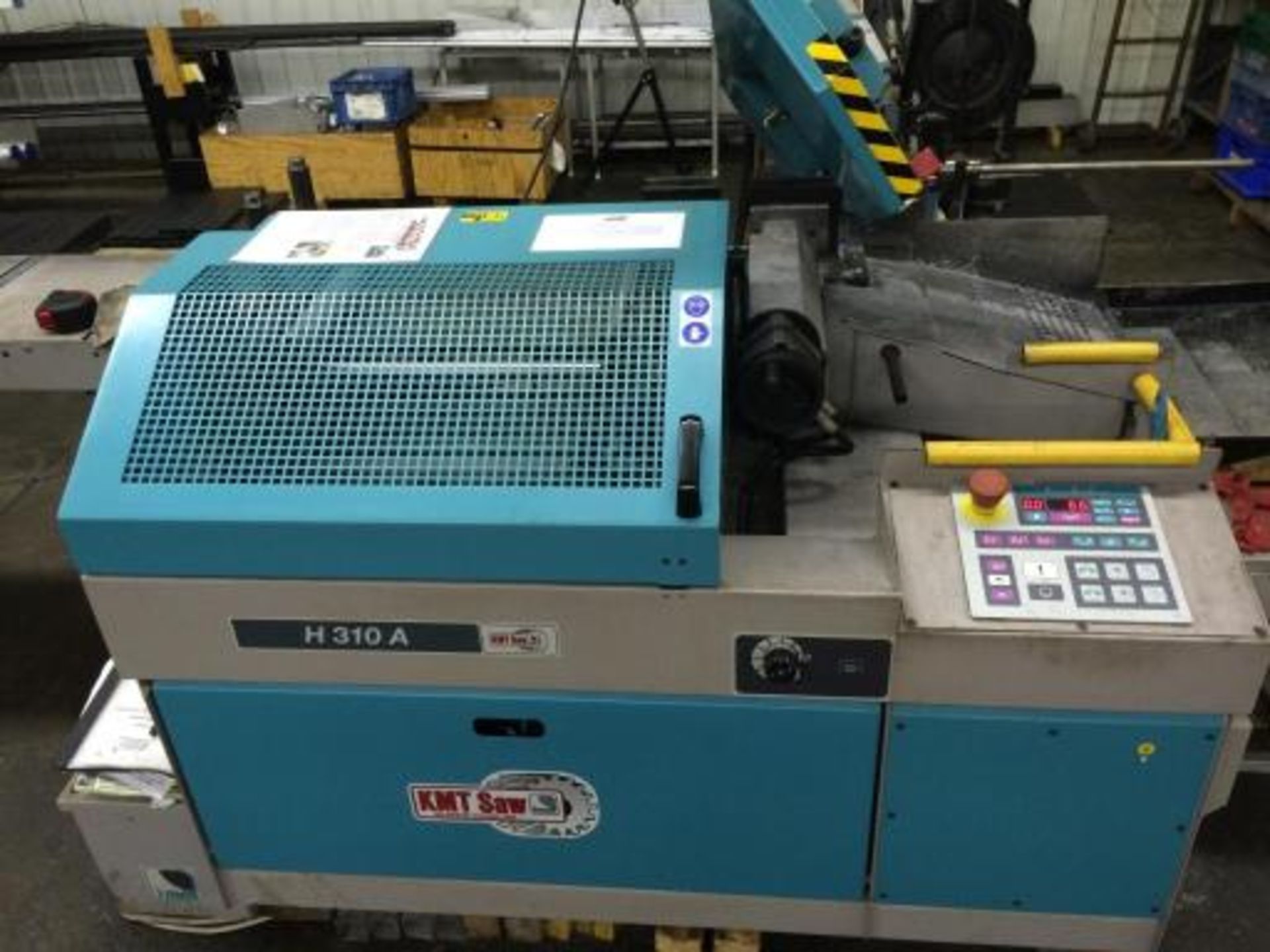 Manufacturer - Commercial / Industrial: KMT Model: H 310A Automated feed band saw in good condition.