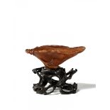 SMALL GOBLET IN THE SHAPE OF A LOTUS LEAF ON A BASE. RHINOCEROS HORN.China. Qing Dynasty. 17th/