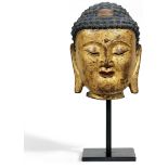 HEAD OF BUDDHA. GILDED BRONZE.China. Ming Dynasty, 15th/16th century.Heavy bronze with lacquer