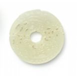 BI DISK IN THE SHAPE OF TWO DRAGONS. JADE. China. Qing Dynasty. 18th century.Almost white, light