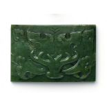 BELT PLATE WITH TAOTIE. JADE. China. Qing Dynasty.Heavy green spinach jade with dark inclusions.