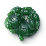 PENDANT. SHIZI LION WITH YOUTH. SPINACH GREEN JADE. China. Middle Qing Dynasty.Very fine spinach