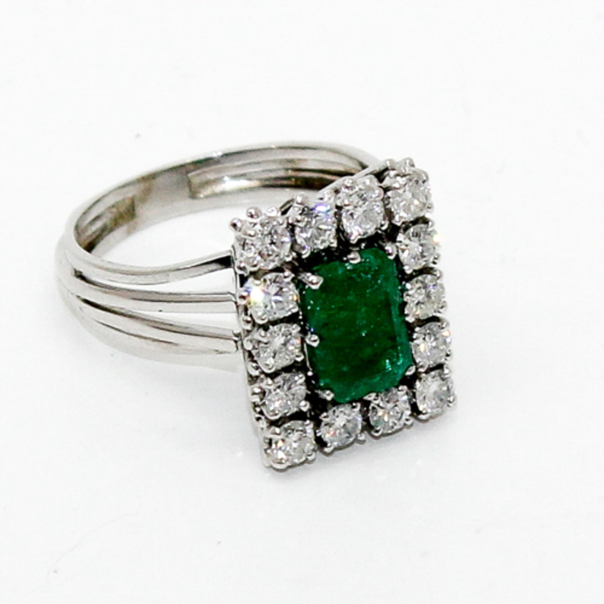 18KWG LADIES EMERALD AND DIAMOND RING Emerald is approximately 3 ct. with surrounding diamond