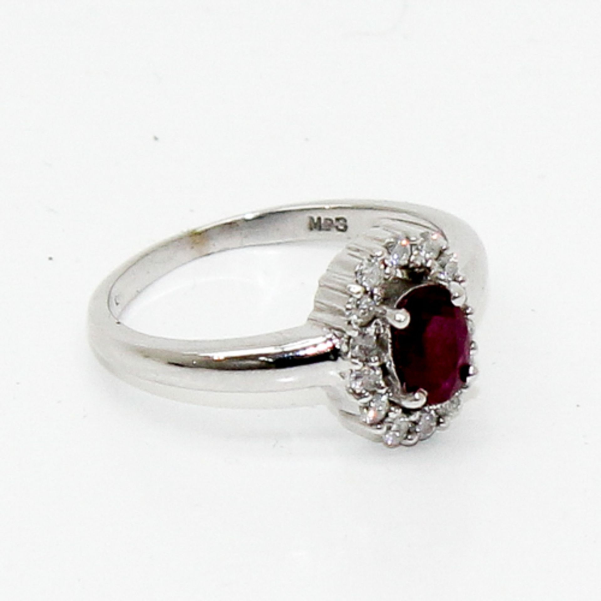 18KWG LADIES RUBY AND DIAMOND RING Central ruby is approximately 1.5 carat, diamond setting is