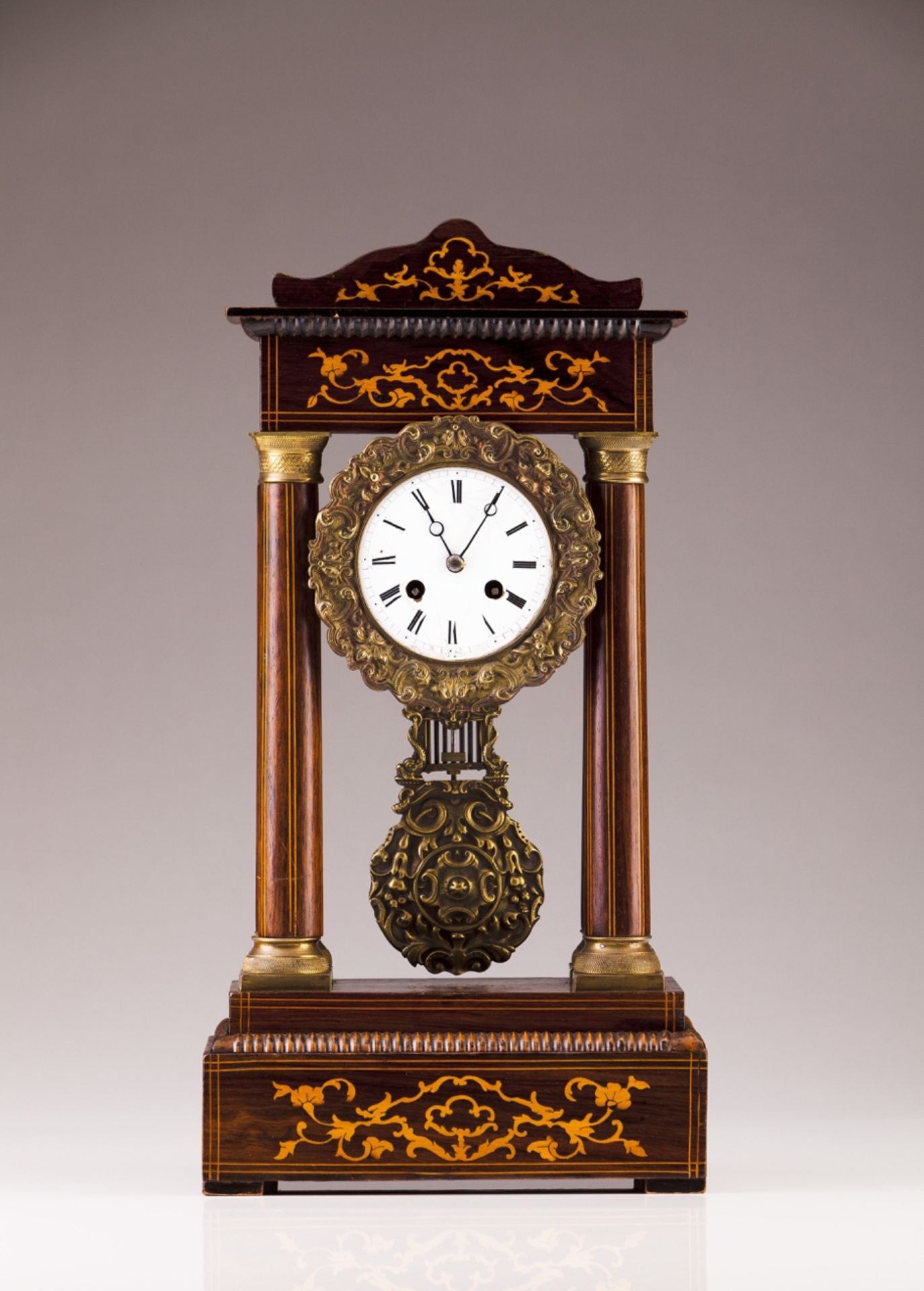 A 19th century French table clock  Rosewood veneered wood with marquetry decoration and brass