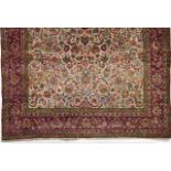 A Persian Sarooq cotton and wool carpet  Of floral and geometric design in blue, beige and coral