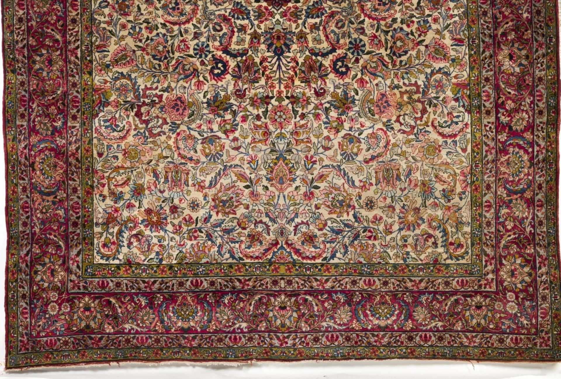 A Persian Sarooq cotton and wool carpet  Of floral and geometric design in blue, beige and coral