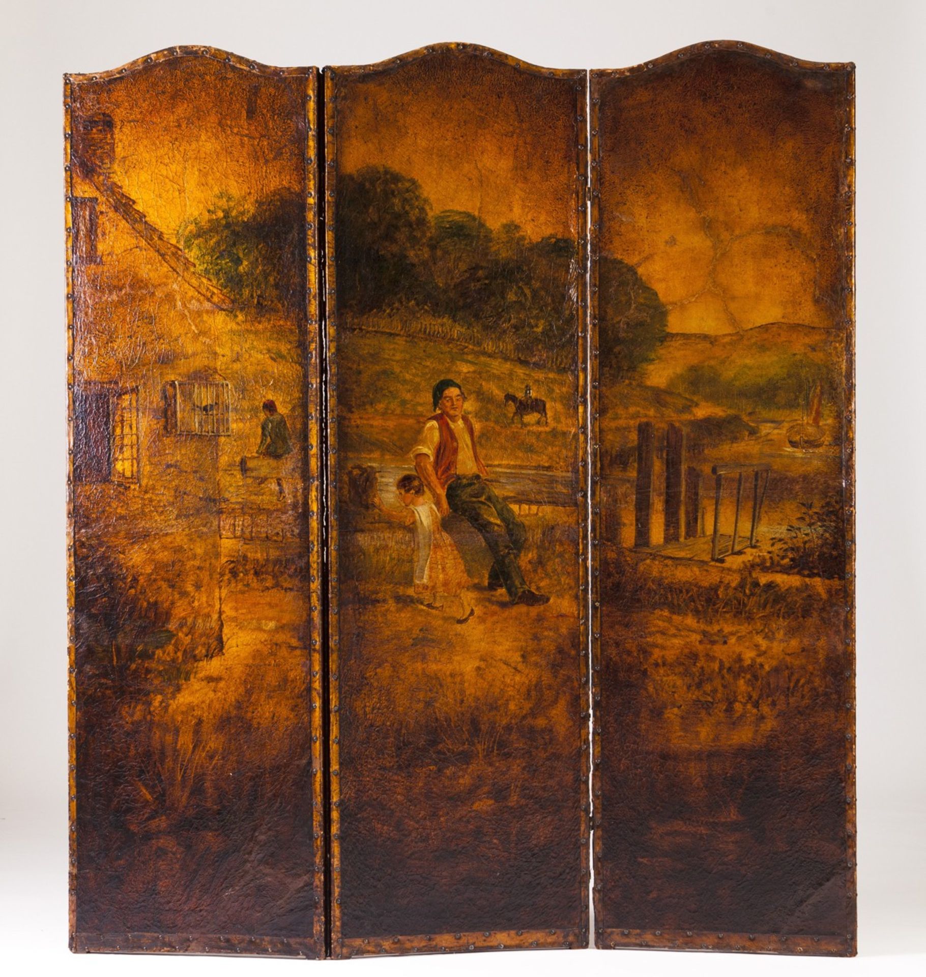 A three-panel folding screen  Painted leather depicting landscapes and figures  England, 19th/20th c